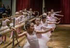 Dziewczynki przy drążku baletowym w różowych strojach